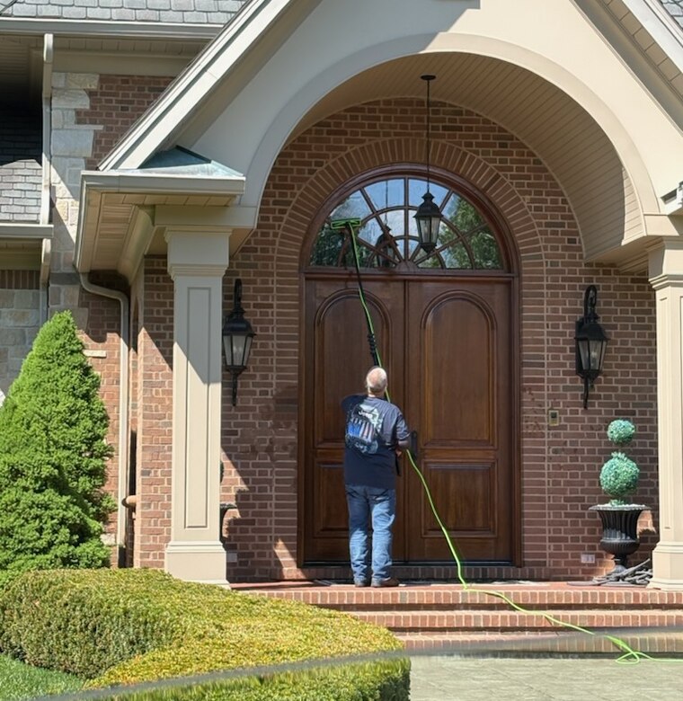 Cleaning an arched entryway window