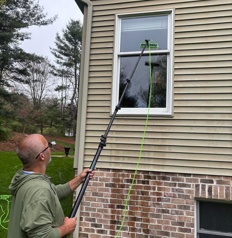 Reaching an upper-floor window with a water-fed pole
